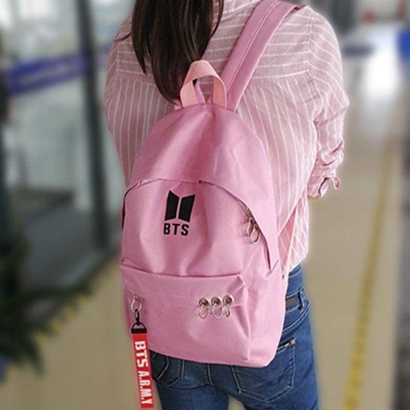 a close up of a girl wearing a pink shirt