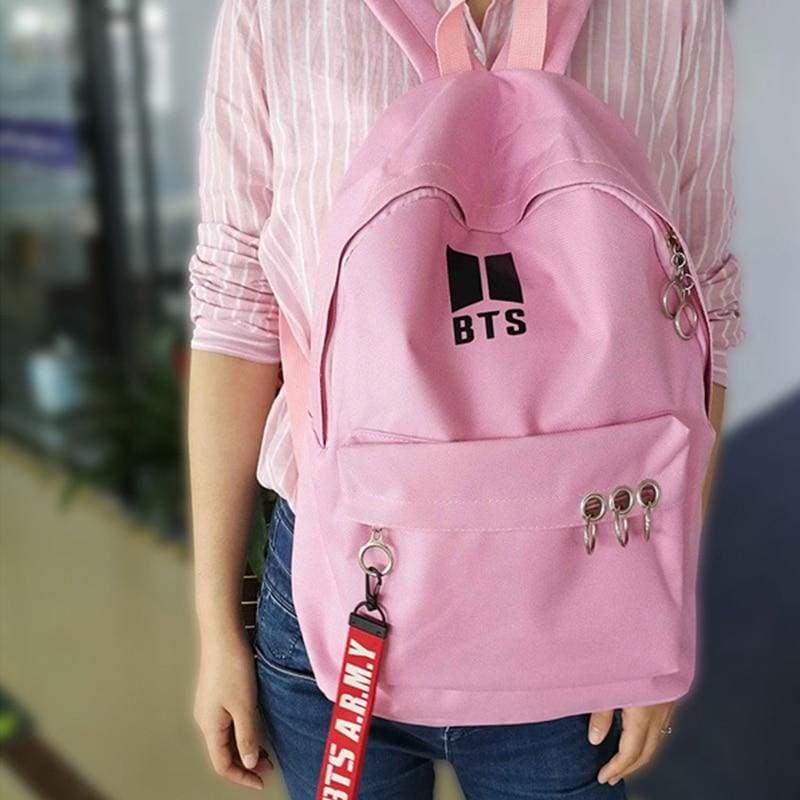 a little girl wearing a pink shirt